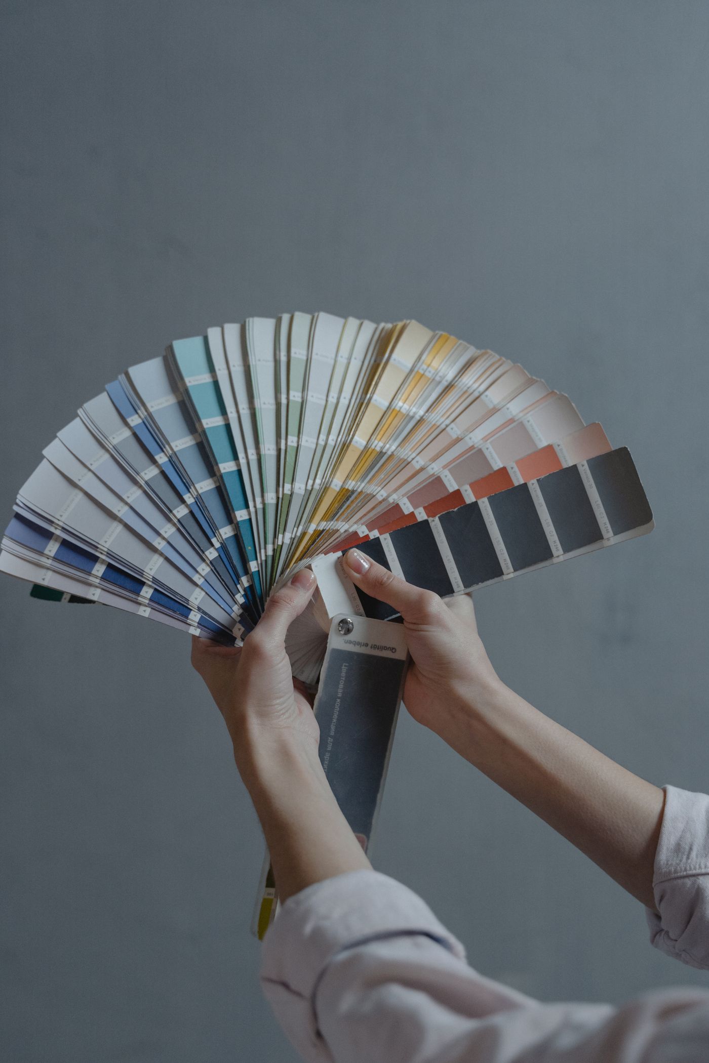 Hands holding colour swatch samples