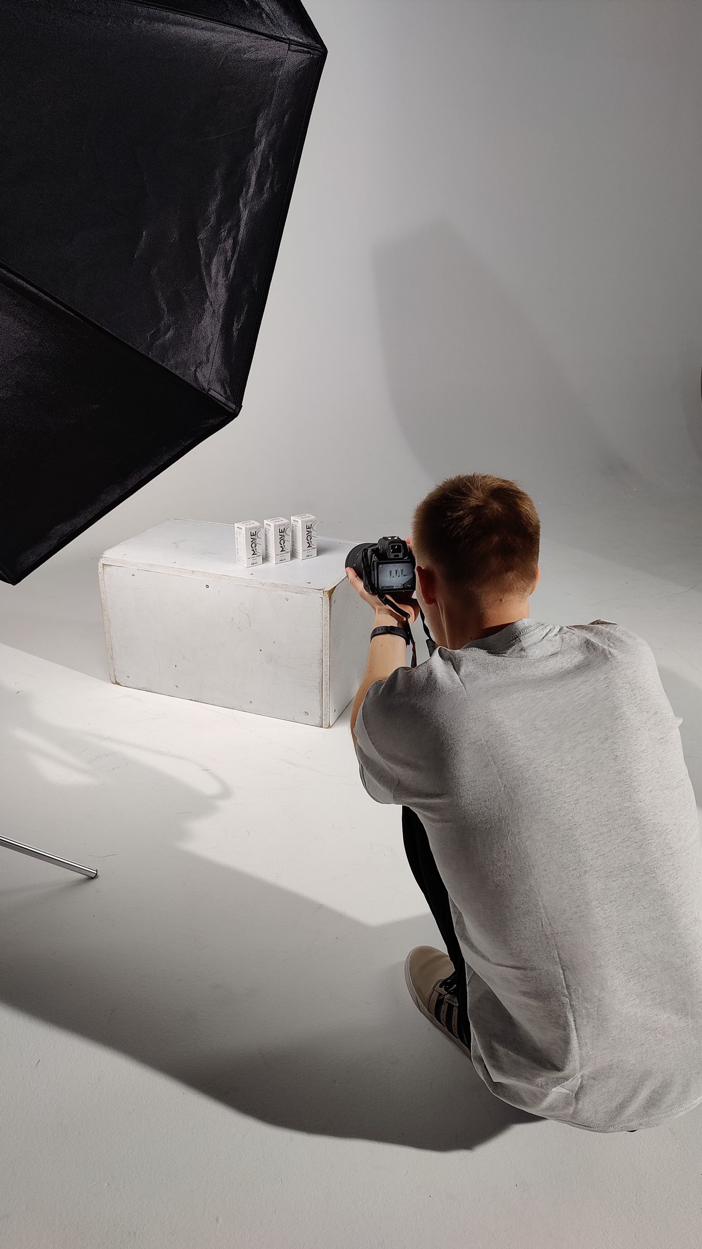 Photographer setting up a studio shoot