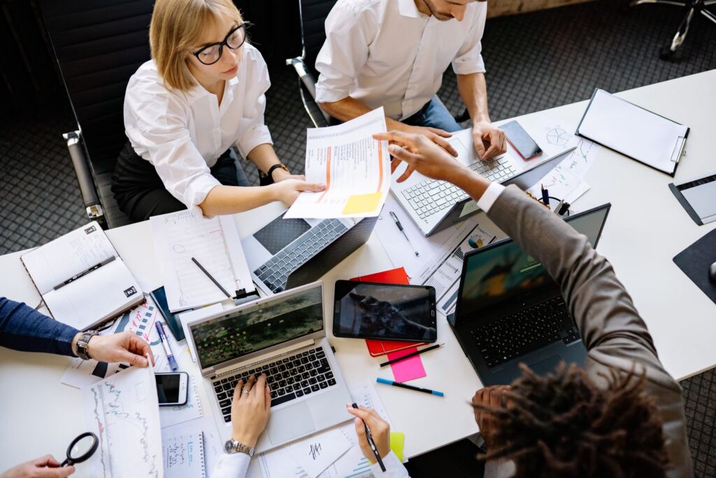 Business team collaborating in a modern office with laptops