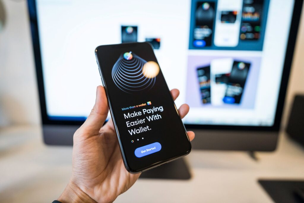Hand holding a smartphone with a digital wallet app