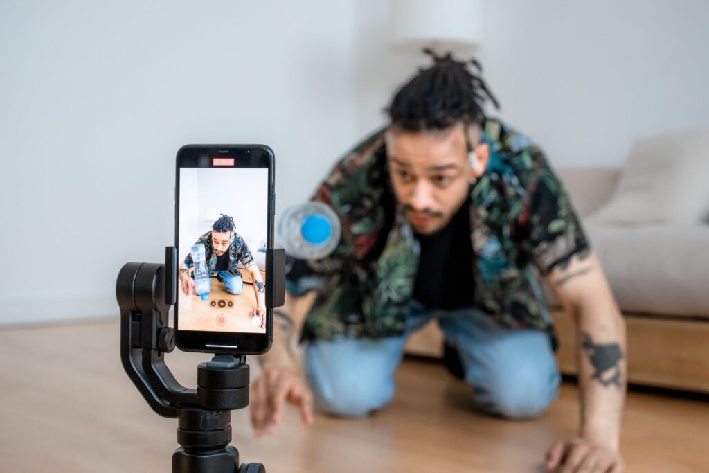 Content creator filming a video with a smartphone on a gimbal