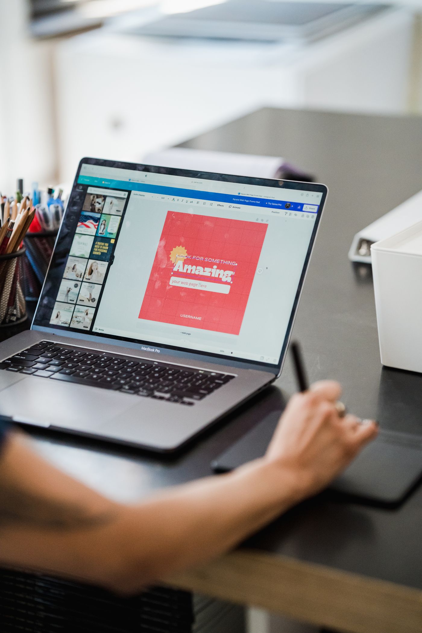 Designer using a graphic tablet and laptop