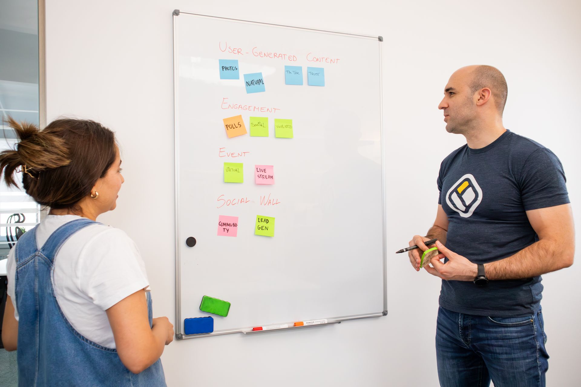 Colleagues planning strategy at a whiteboard