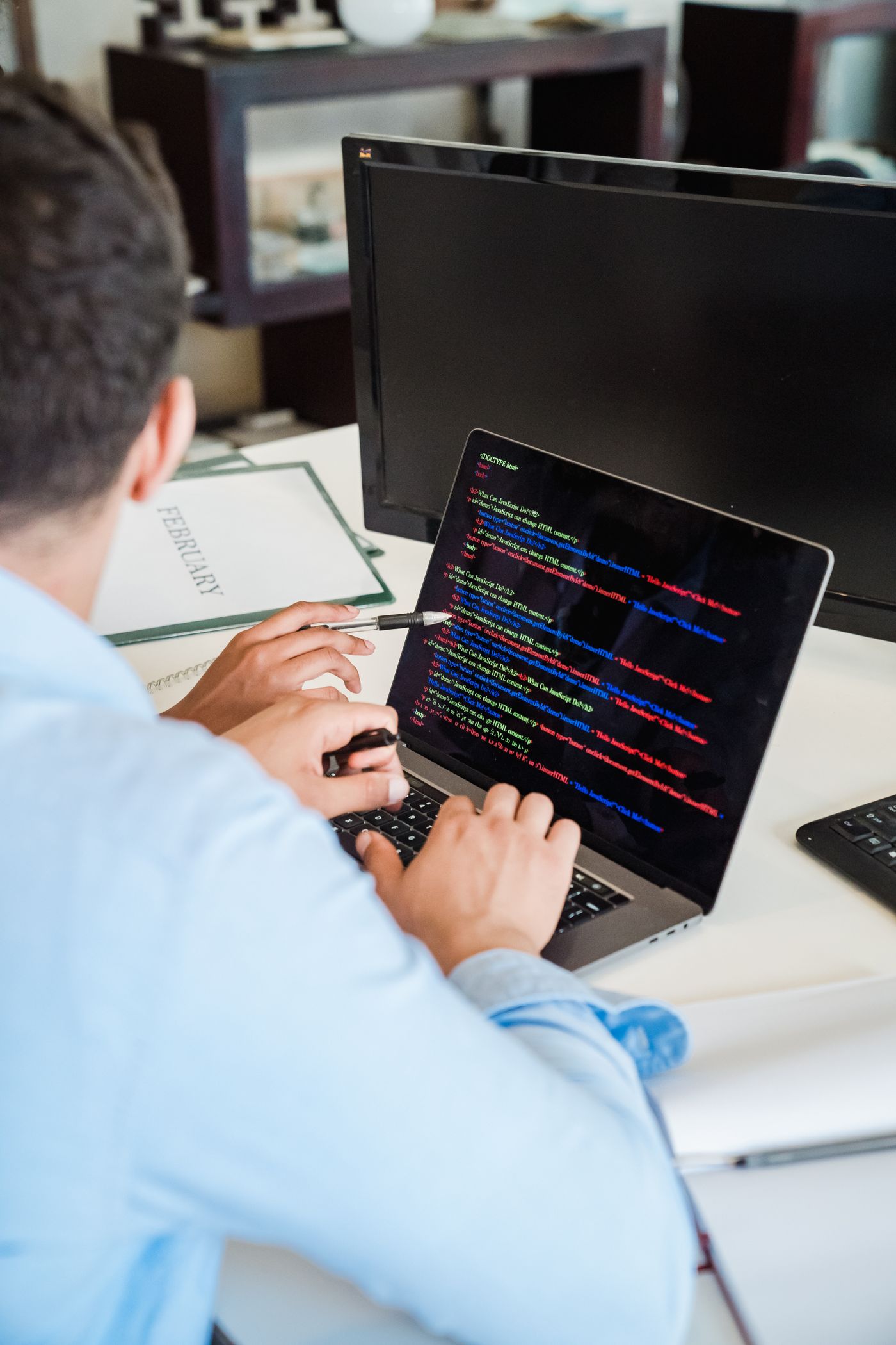 Developer writing code on a laptop