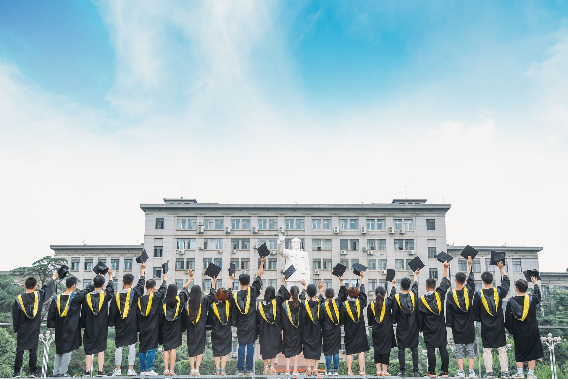 Graduates celebrating outside a university