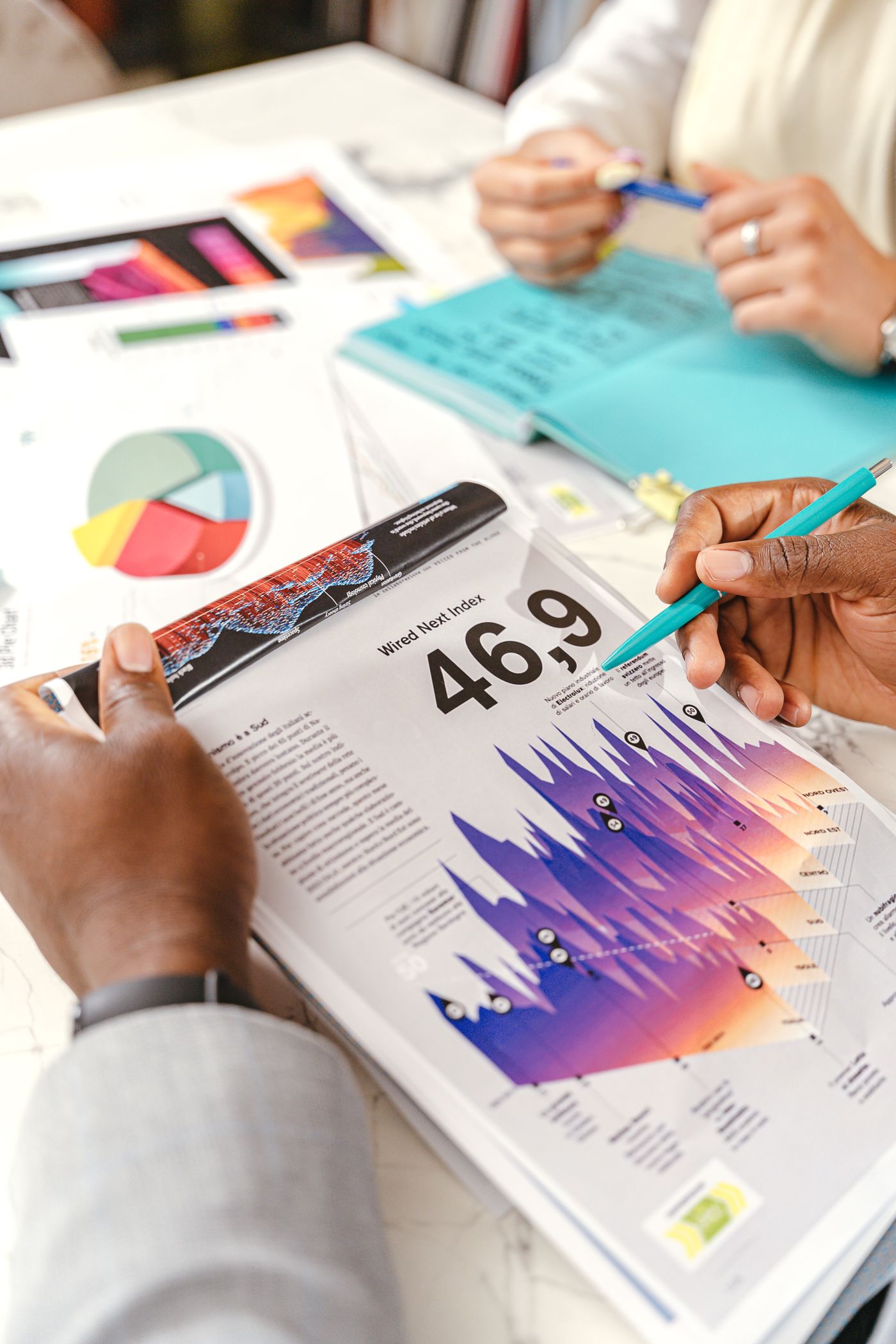 Hands reviewing marketing charts