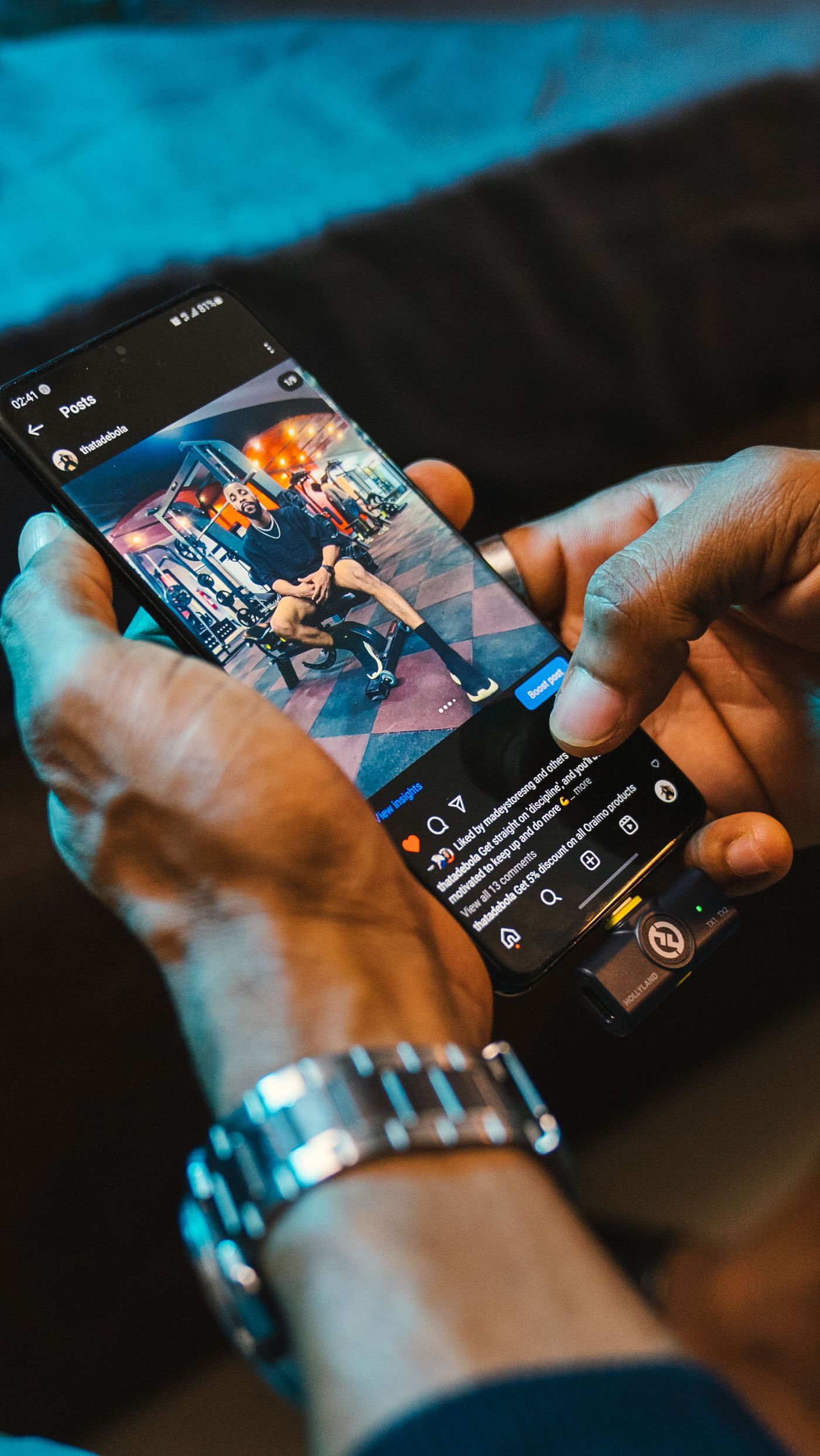 Hands browsing a social feed on a phone